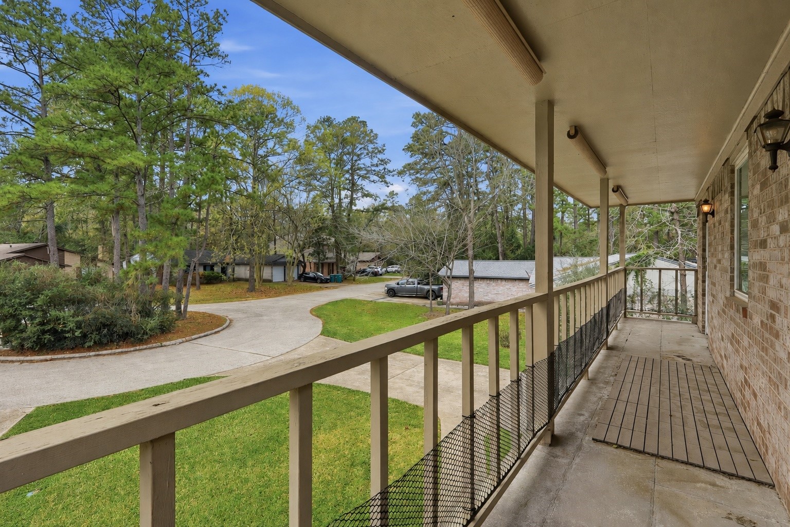 10 East Broken Oak Court Spring, TX 77381 - Photo 3 of 31 Covered second-story porch shared by the primary suite and secondary bedroom, offering a unique outdoor space with cul-de-sac views.