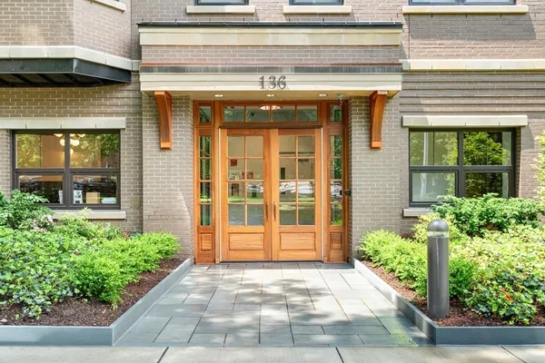 a view of a patio with a dining table and chairs with wooden floor