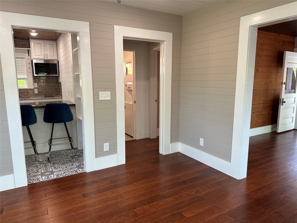 1223 1/2 South Austin Avenue Georgetown, TX 78626 - Photo 16 of 39 a view of an empty room with wooden floor and a bathroom