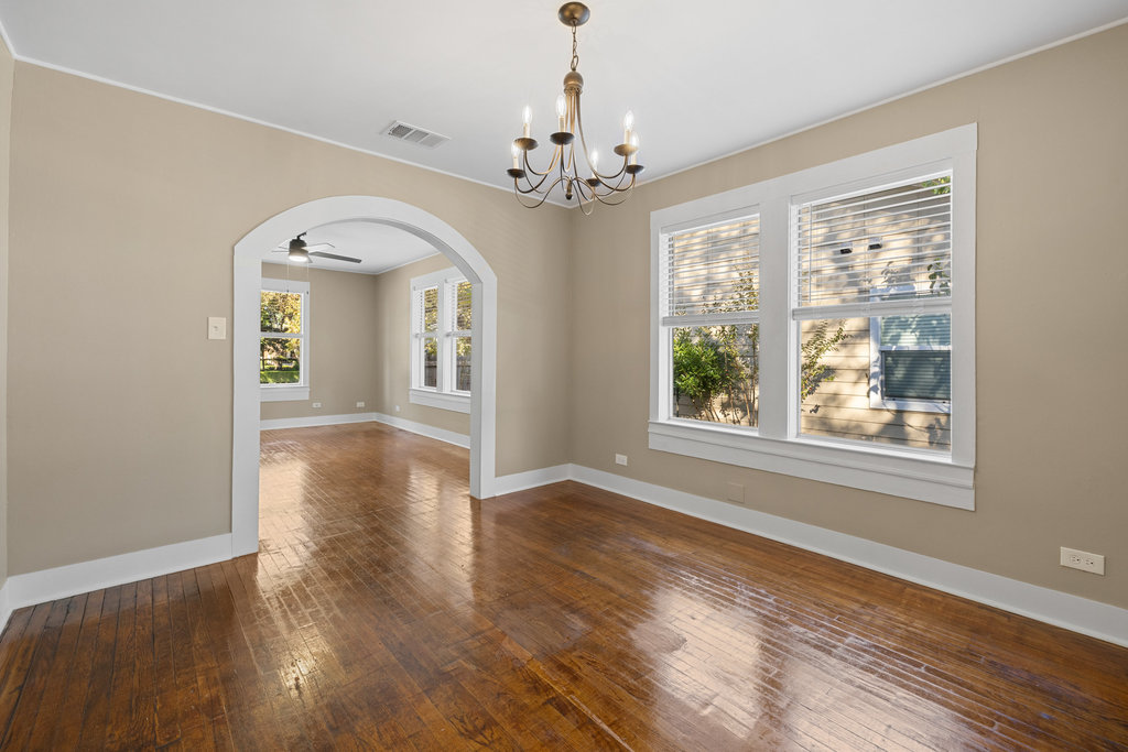 1223 1/2 South Austin Avenue Georgetown, TX 78626 - Photo 4 of 39 a view of a room with wooden floors chandelier and windows