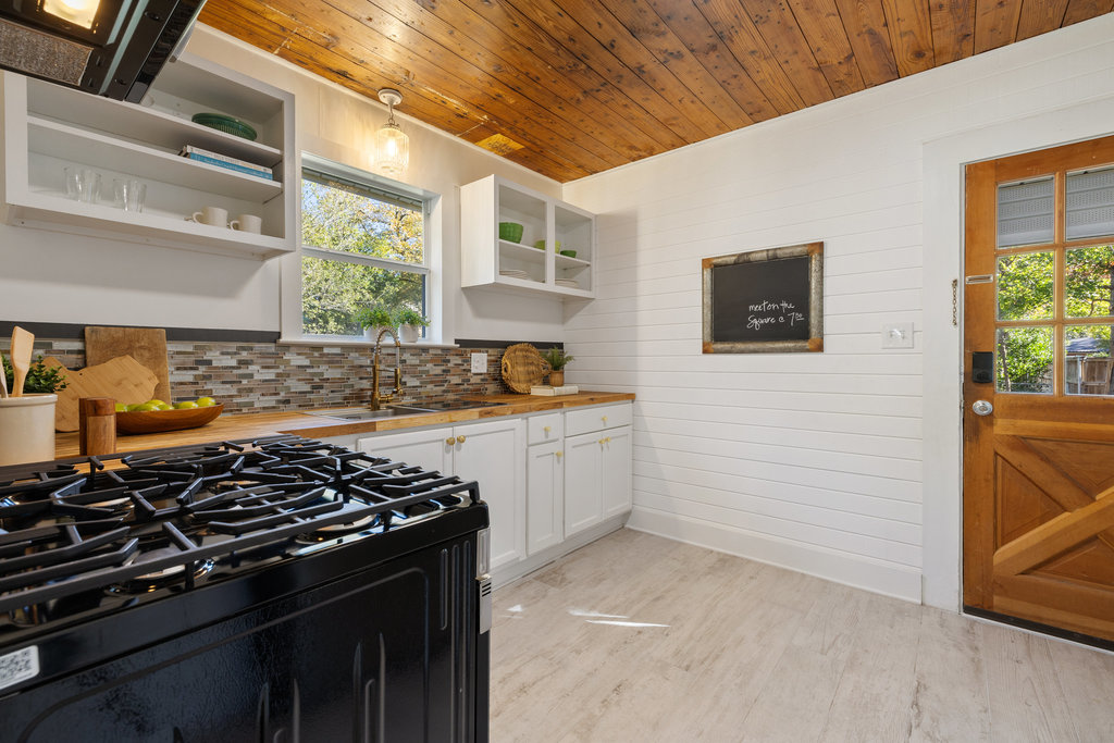 1223 1/2 South Austin Avenue Georgetown, TX 78626 - Photo 6 of 39 a kitchen with a stove and a refrigerator