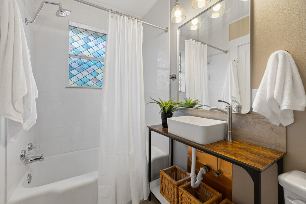 1223 1/2 South Austin Avenue Georgetown, TX 78626 - Photo 8 of 39 a bathroom with a sink a mirror and a shower