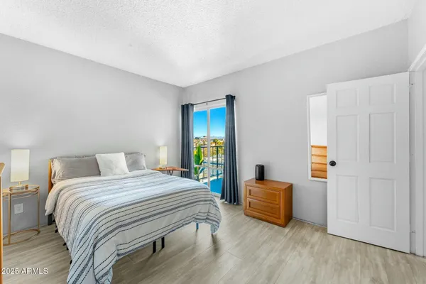 a bedroom with a bed and wooden floor