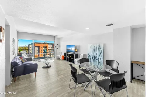 a living room with fireplace furniture and a wooden floor