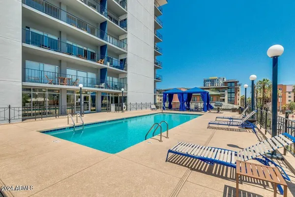 a view of swimming pool with a lounge chairs
