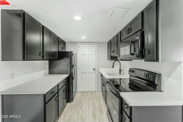 a kitchen that has a sink and a stove in it