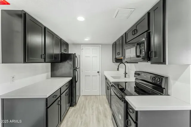a kitchen that has a sink and a stove in it