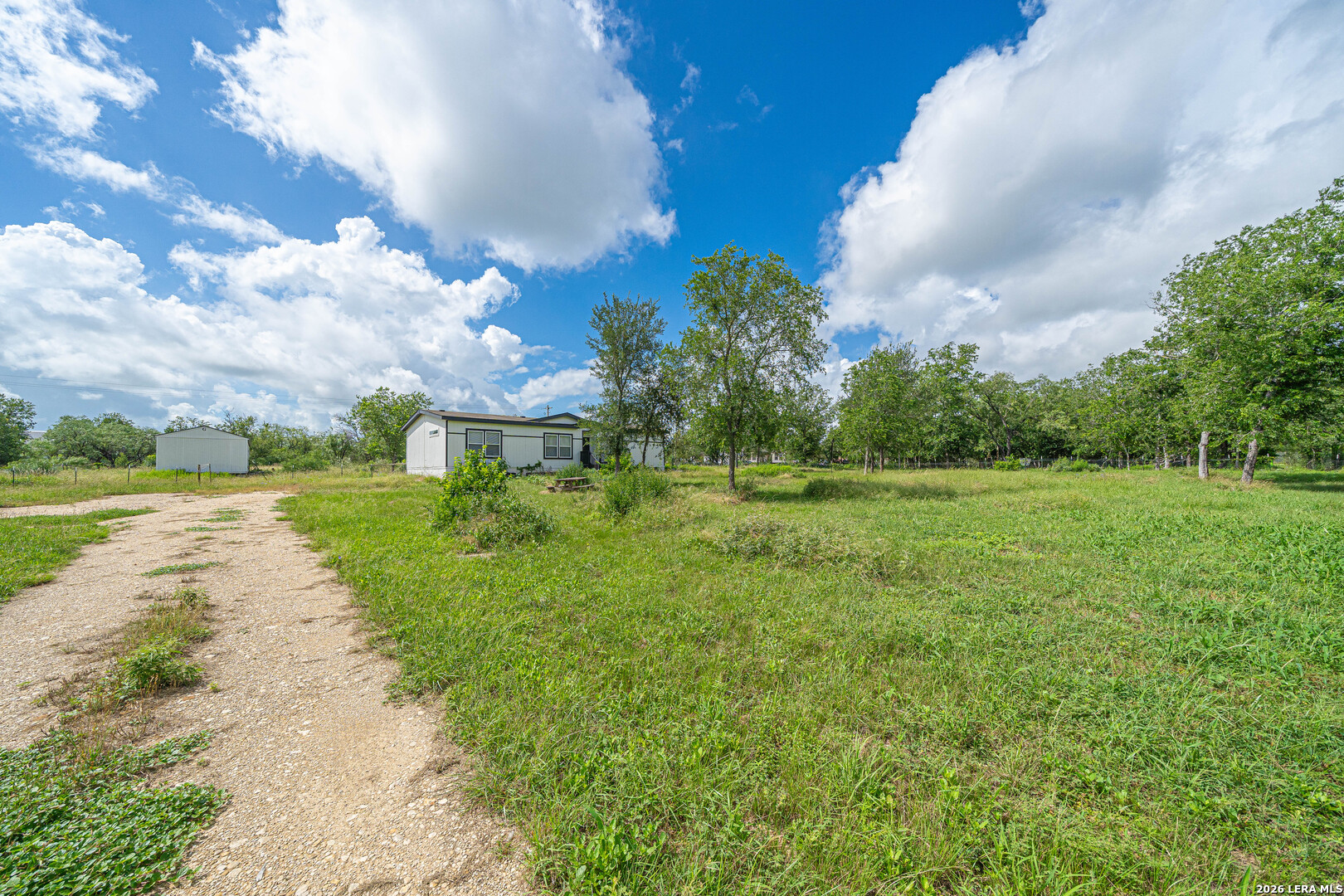 3433 Gander Slough Road Kingsbury, TX 78638 - Photo 2 of 23 a view of a garden with a building in the background