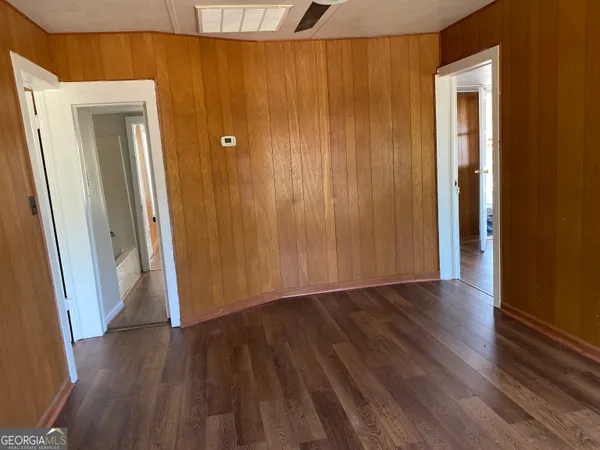 a view of a hallway with wooden floor