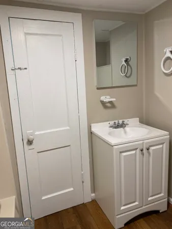 a bathroom with a sink a toilet and a mirror