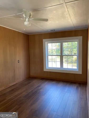 wooden floor in an empty room with a window