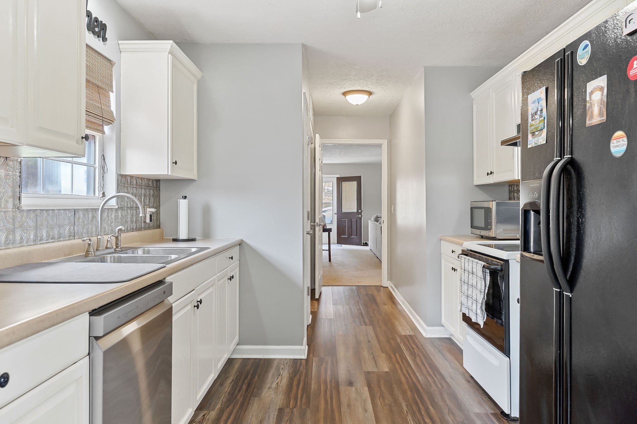 249 Darlene Drive Sparta, TN 38583 - Photo 5 of 21 a kitchen with a sink dishwasher a refrigerator and wooden floor
