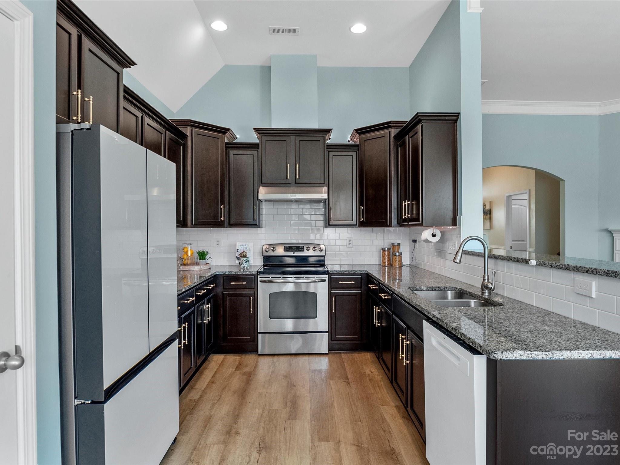 78005 Rillstone Drive Lancaster, SC 29720 - Photo 7 of 41 a kitchen with stainless steel appliances granite countertop a refrigerator a sink a stove and cabinets