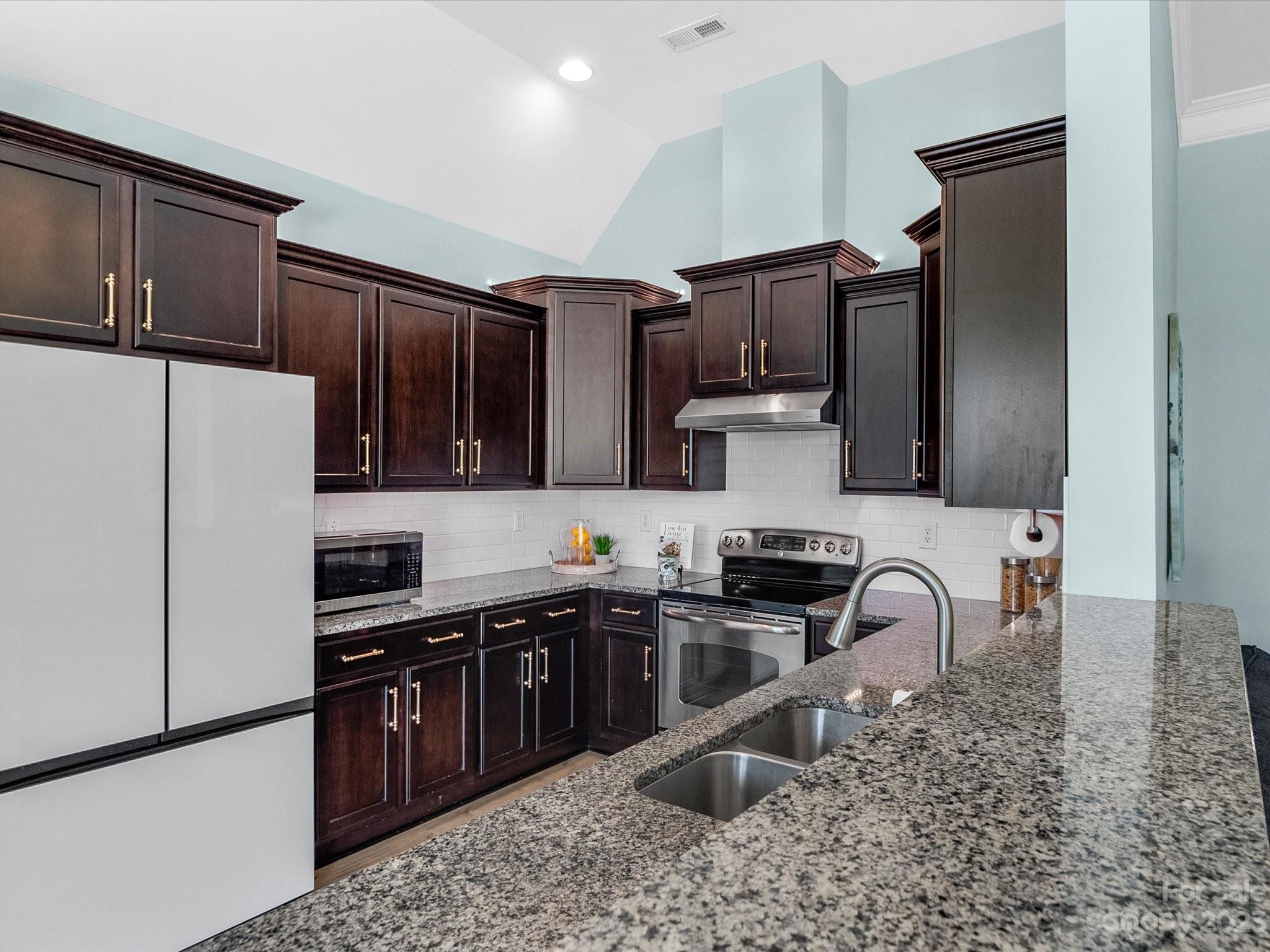 78005 Rillstone Drive Lancaster, SC 29720 - Photo 8 of 41 a kitchen with stainless steel appliances granite countertop a sink stove and refrigerator