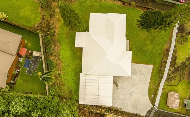 an aerial view of a house with pool table and chairs