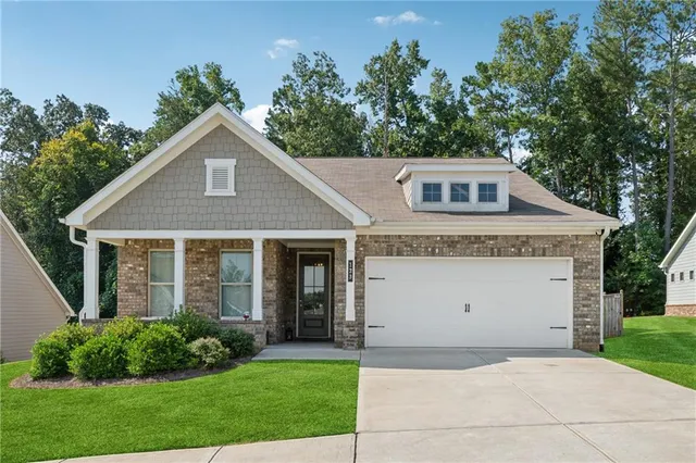a front view of a house with a garden