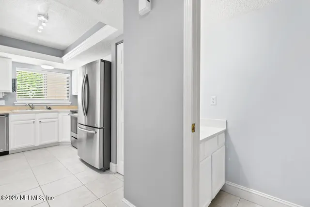 a kitchen with stainless steel appliances granite countertop a stove a refrigerator and a sink