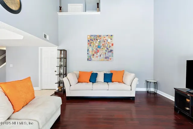 a bedroom with a bed flat screen tv and window