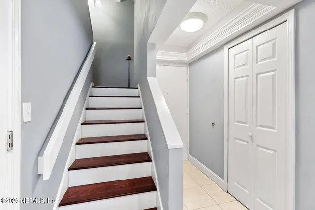 a bathroom with a sink a toilet a mirror and shower curtain