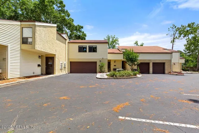a front view of a house with garage and garage