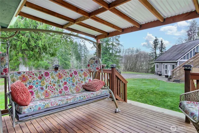 a view of a house with backyard and sitting area