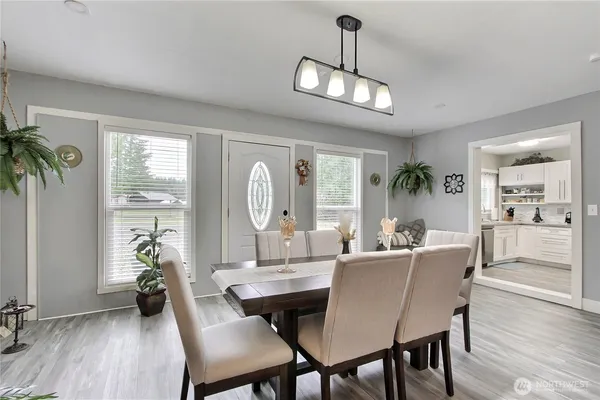 a view of a dining room with furniture wooden floor and chandelier