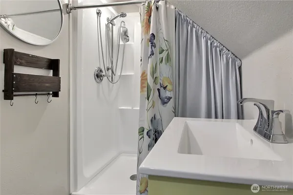 a bathroom with a sink a toilet and mirror