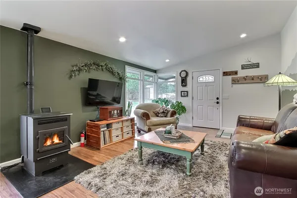 a living room with furniture a flat screen tv and a fireplace