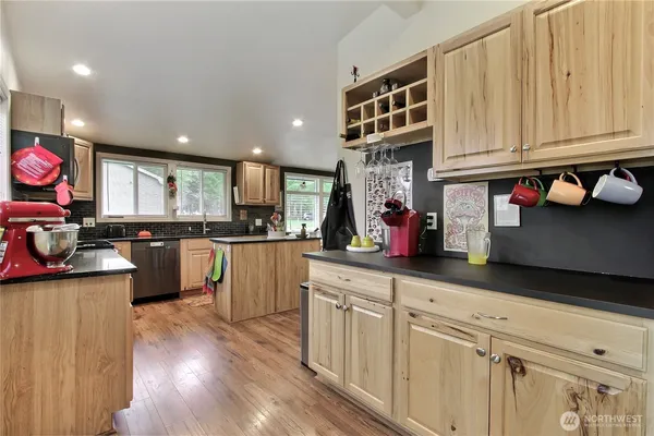 a kitchen with cabinets and wooden floor