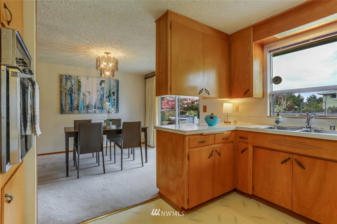 11222 Southeast 182nd Street Renton, WA 98055 - Photo 11 of 24 a kitchen with cabinets and chairs