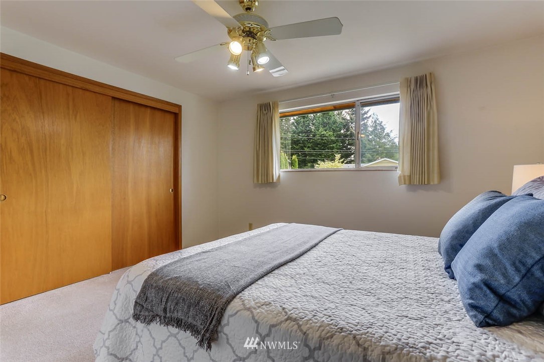 11222 Southeast 182nd Street Renton, WA 98055 - Photo 15 of 24 a bedroom with a bed and a window