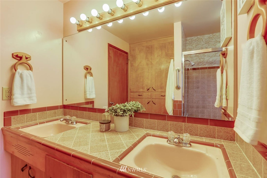 11222 Southeast 182nd Street Renton, WA 98055 - Photo 18 of 24 a bathroom with a sink and a mirror