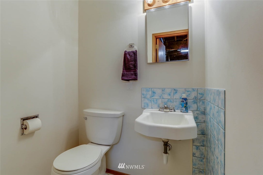 11222 Southeast 182nd Street Renton, WA 98055 - Photo 20 of 24 a bathroom with a sink mirror and toilet