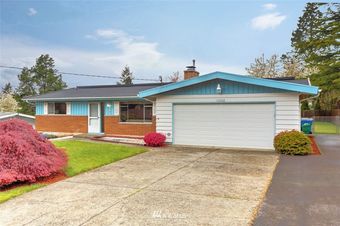 11222 Southeast 182nd Street Renton, WA 98055 - Photo 23 of 24 a front view of a house with a yard and garage