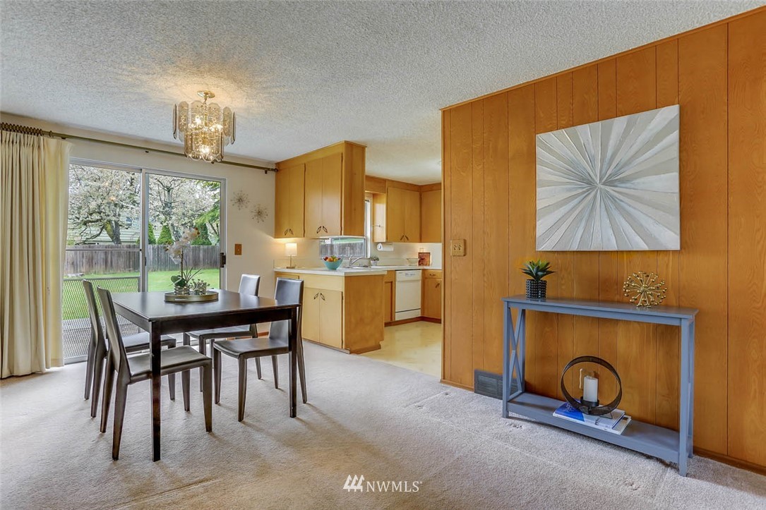 11222 Southeast 182nd Street Renton, WA 98055 - Photo 6 of 24 a view of a dining room with furniture and a fireplace