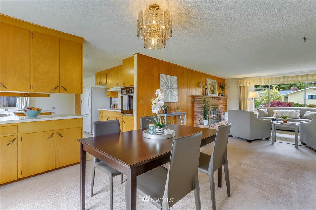 11222 Southeast 182nd Street Renton, WA 98055 - Photo 7 of 24 a dining room with furniture a chandelier and window