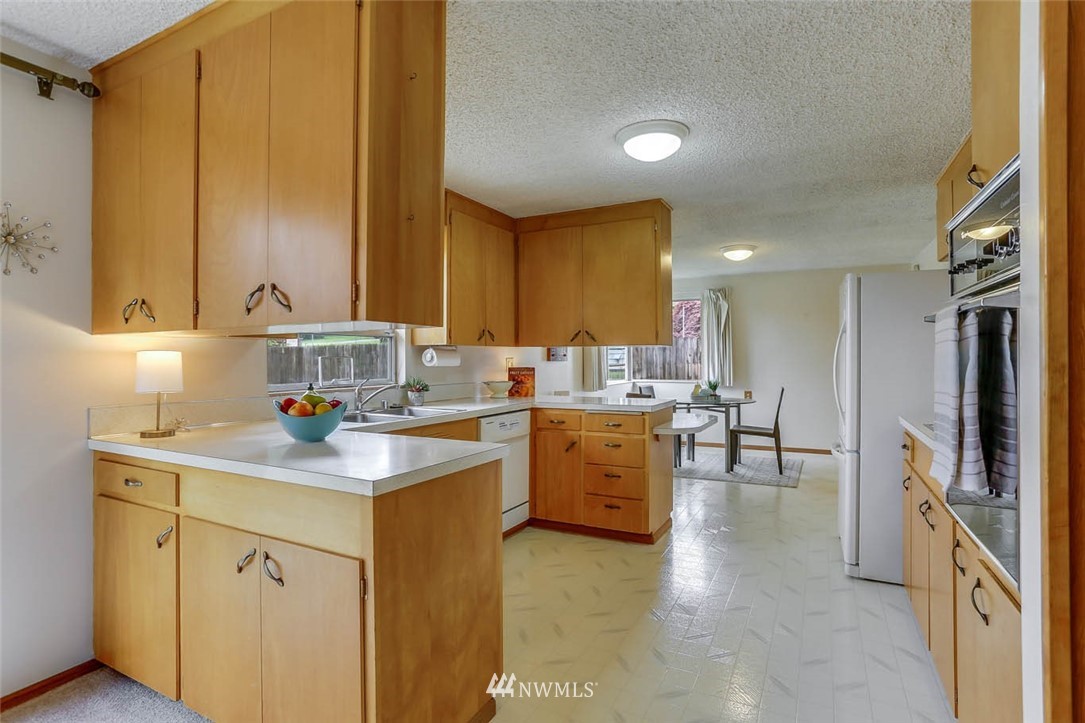 11222 Southeast 182nd Street Renton, WA 98055 - Photo 8 of 24 a kitchen with a sink cabinets and window