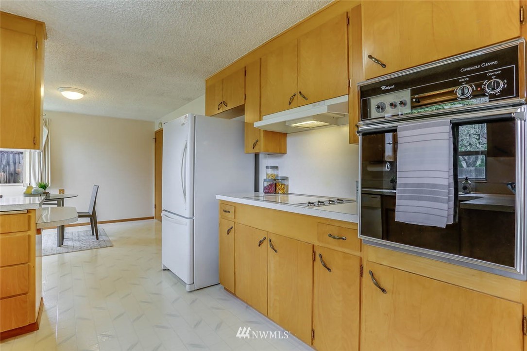11222 Southeast 182nd Street Renton, WA 98055 - Photo 9 of 24 a kitchen with stainless steel appliances granite countertop a sink and cabinets
