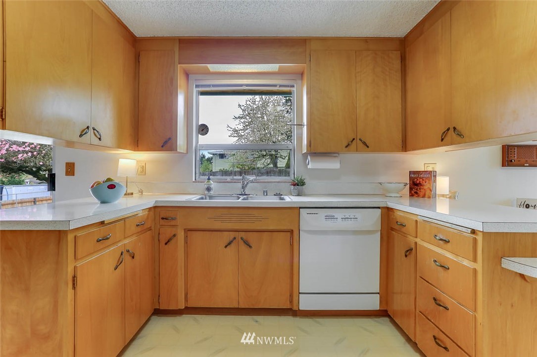 11222 Southeast 182nd Street Renton, WA 98055 - Photo 10 of 24 a kitchen with stainless steel appliances a sink stove and cabinets