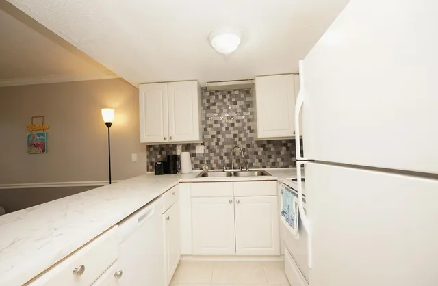 a kitchen with a refrigerator and a sink