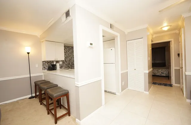 a view of kitchen with furniture and a refrigerator