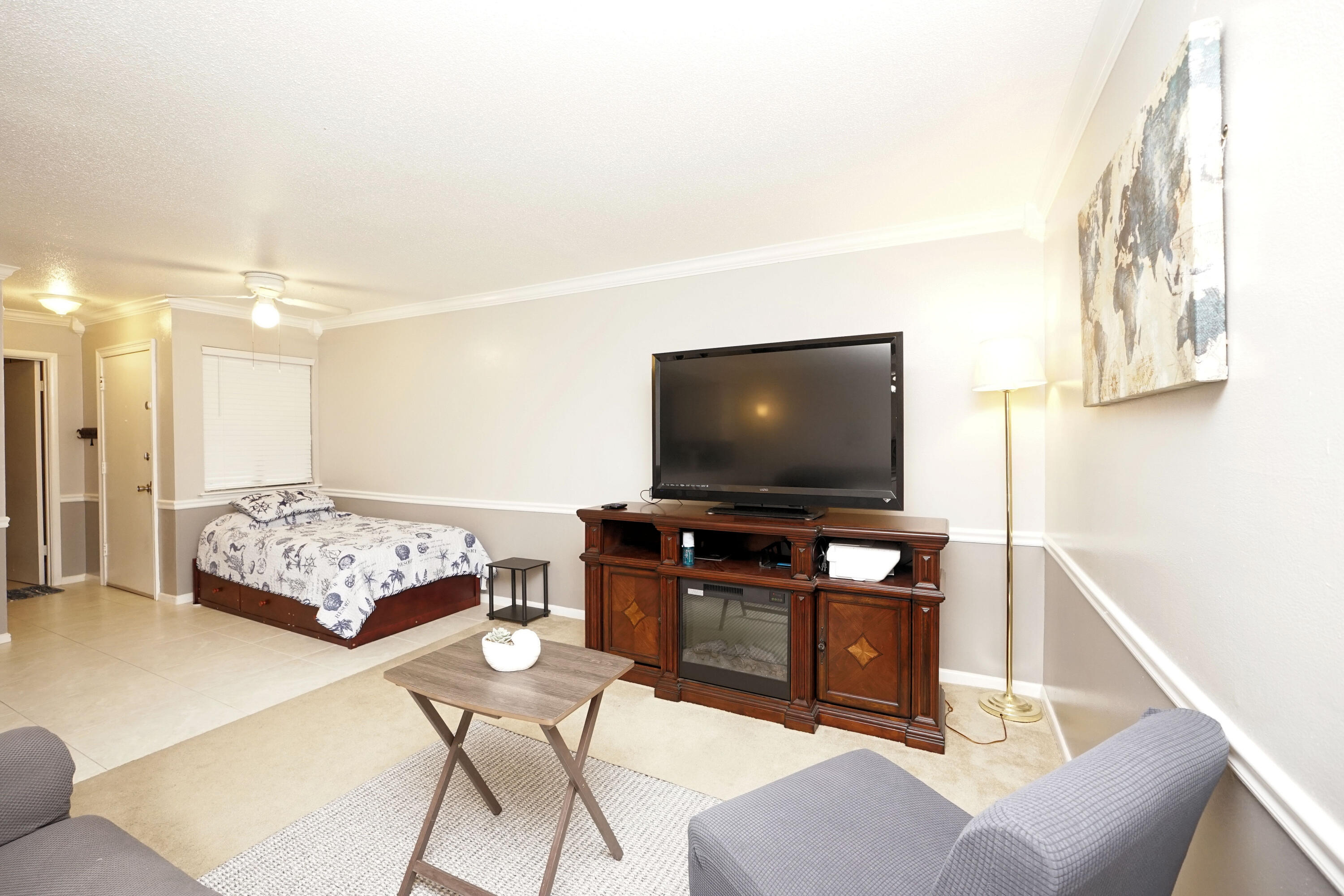 308 Miracle Strip Parkway Southwest, Unit 7D Fort Walton Beach, FL 32548 - Photo 15 of 34 a living room with furniture and a flat screen tv