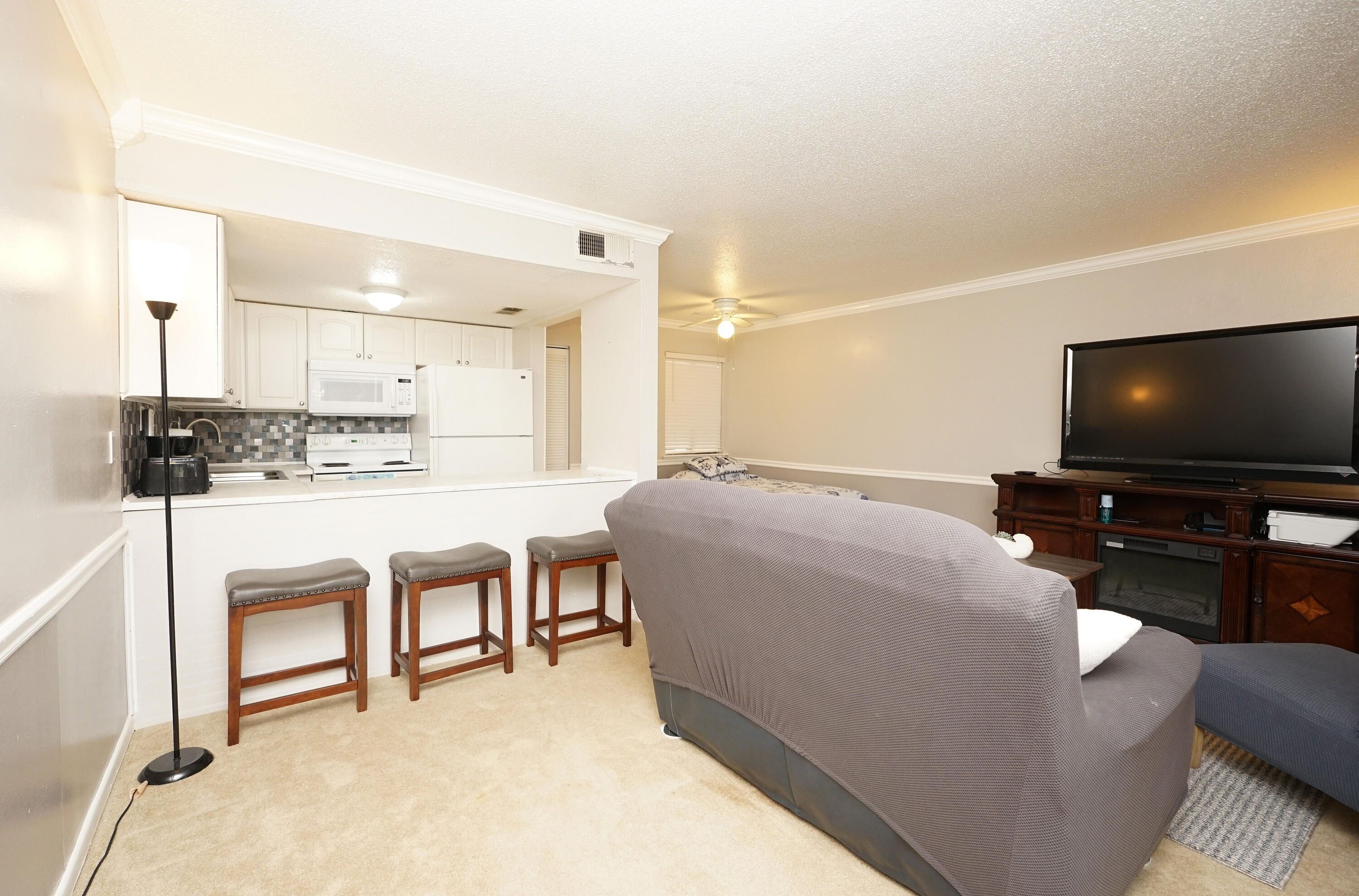 308 Miracle Strip Parkway Southwest, Unit 7D Fort Walton Beach, FL 32548 - Photo 18 of 34 a living room with furniture and a flat screen tv