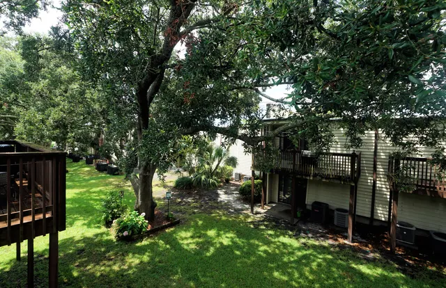 a view of a house with a tree in a yard
