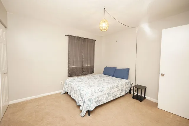 a bedroom with a bed and a table