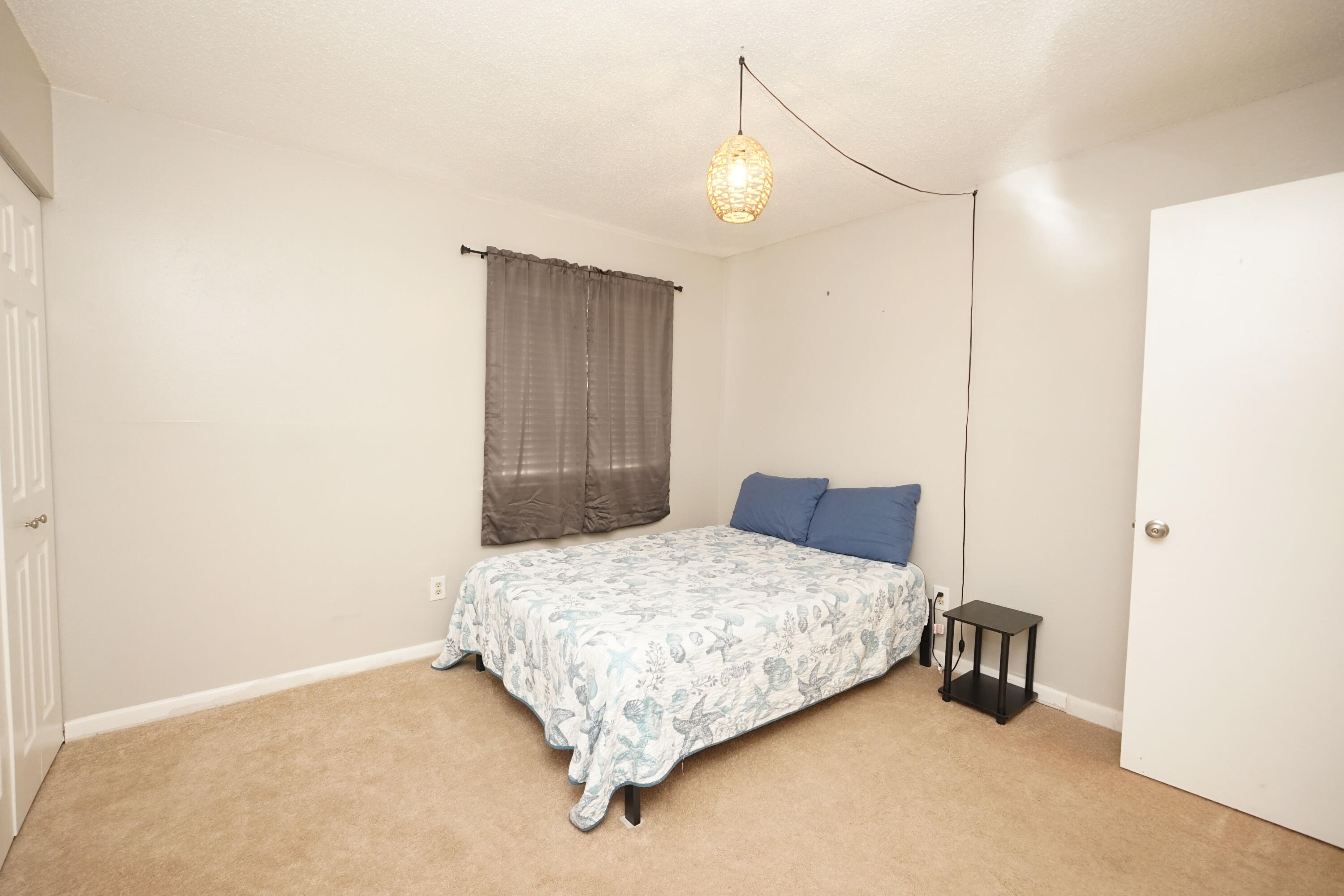 308 Miracle Strip Parkway Southwest, Unit 7D Fort Walton Beach, FL 32548 - Photo 23 of 34 a bedroom with a bed and a table