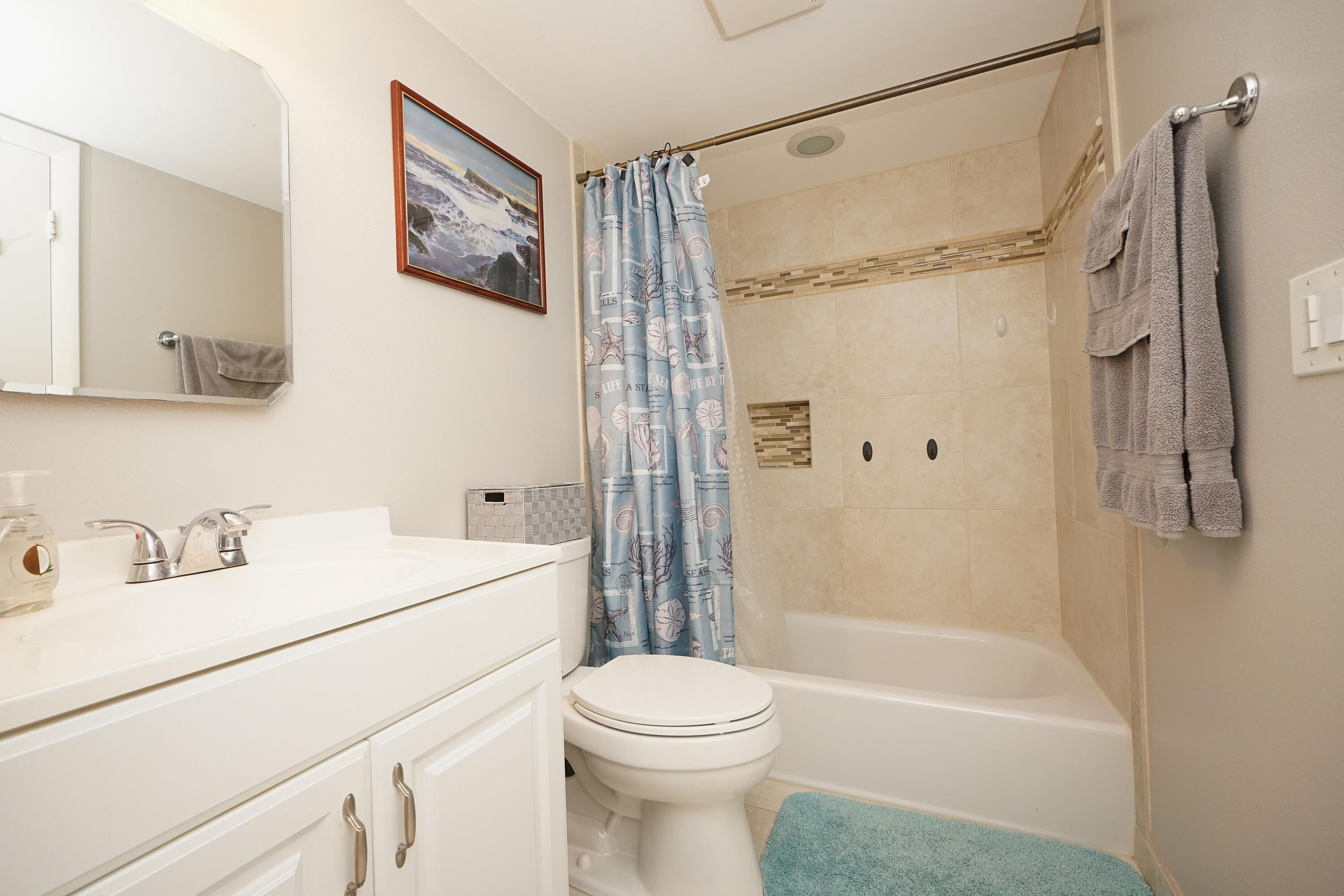 308 Miracle Strip Parkway Southwest, Unit 7D Fort Walton Beach, FL 32548 - Photo 25 of 34 a bathroom with a sink a toilet and a bathtub