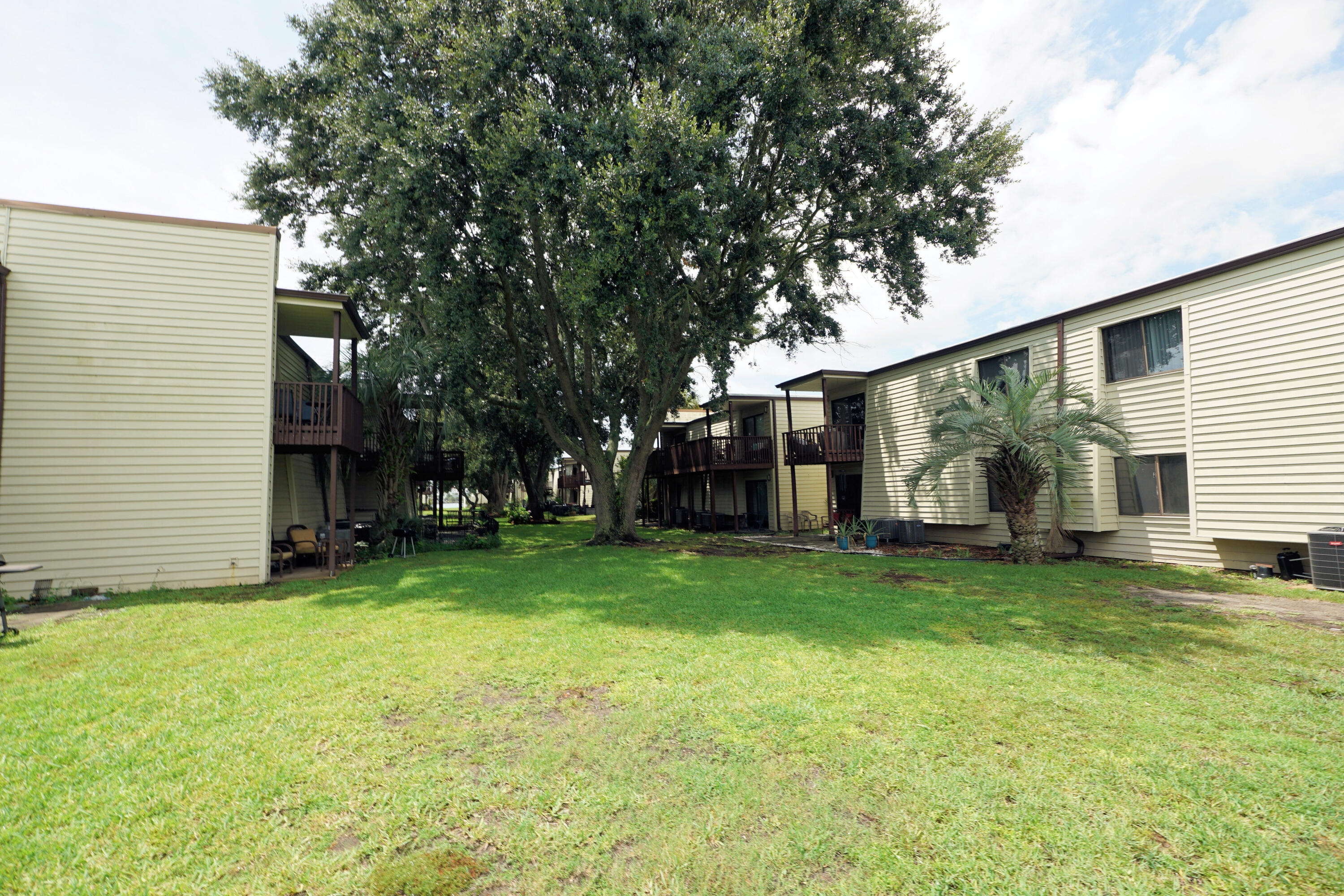 308 Miracle Strip Parkway Southwest, Unit 7D Fort Walton Beach, FL 32548 - Photo 26 of 34 a view of a house with a backyard