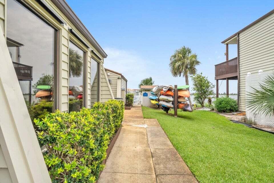 308 Miracle Strip Parkway Southwest, Unit 7D Fort Walton Beach, FL 32548 - Photo 29 of 34 a view of a patio with couches table and chairs and potted plants