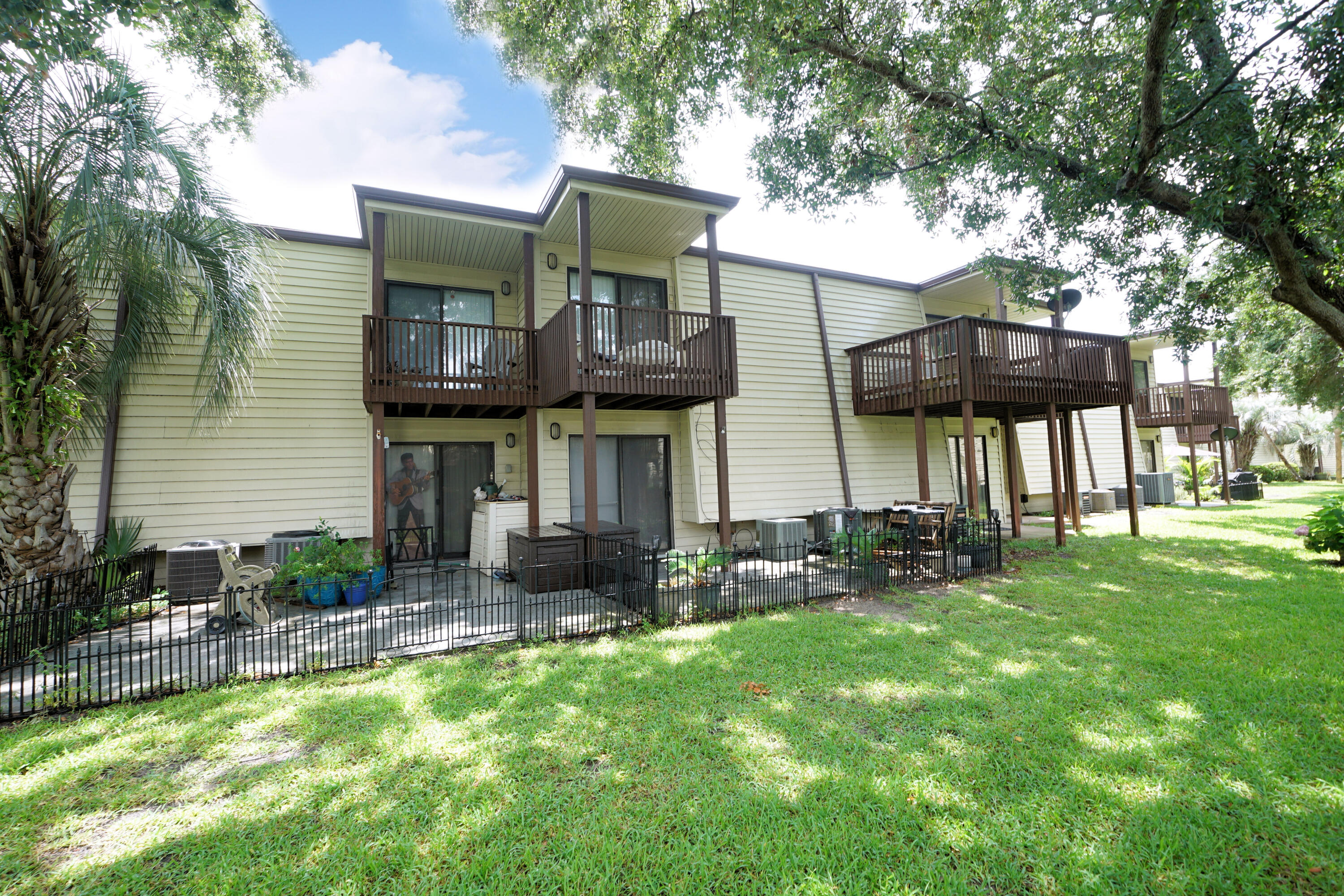 308 Miracle Strip Parkway Southwest, Unit 7D Fort Walton Beach, FL 32548 - Photo 3 of 34 a view of a house with a yard and sitting area